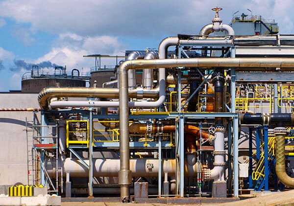 Industrial process plant with pipelines and equipment representing process safety culture and operational risk management.