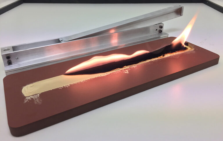 UN Test N.1 flammability of solids showing powder strip ignition during UN transportation classification testing.