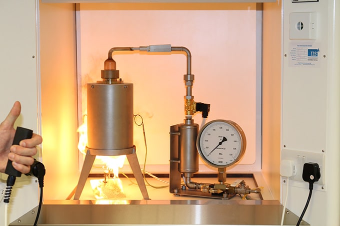 Apparatus performing combustible dust testing to evaluate explosion hazards of dust samples.