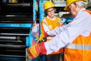 Engineer conducting Preliminary Hazard Assessment at a manufacturing site.
