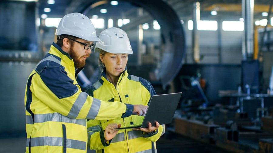 Two engineers discussing process safety consulting solutions in an industrial setting.